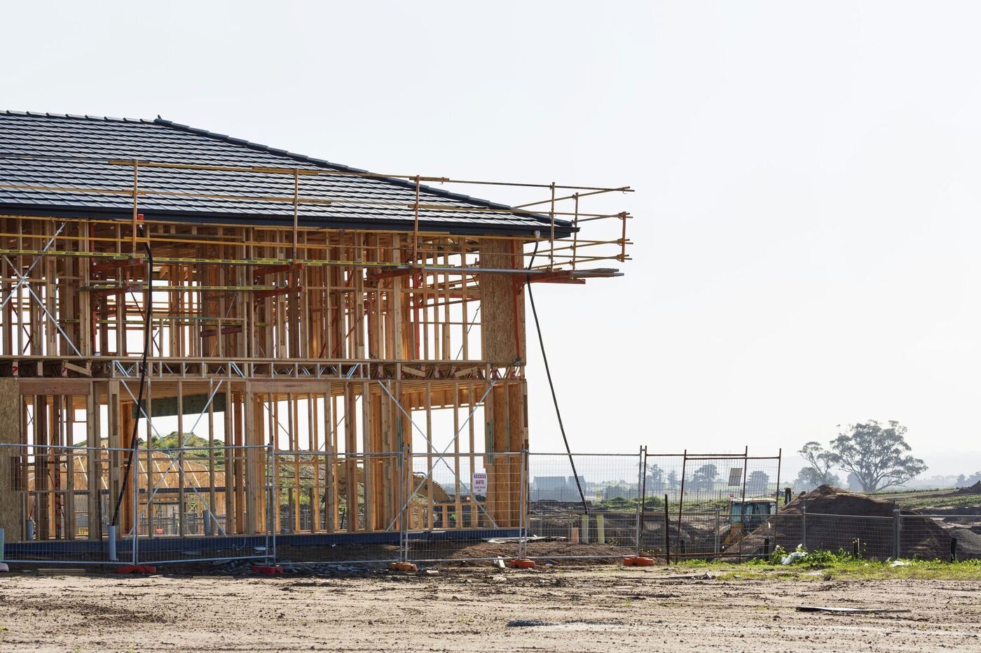 A house under construction with scaffolding in a new Victorian housing estate